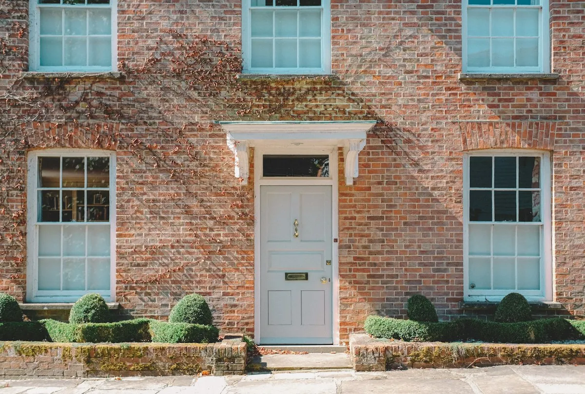 Panelled front door on a brick house
