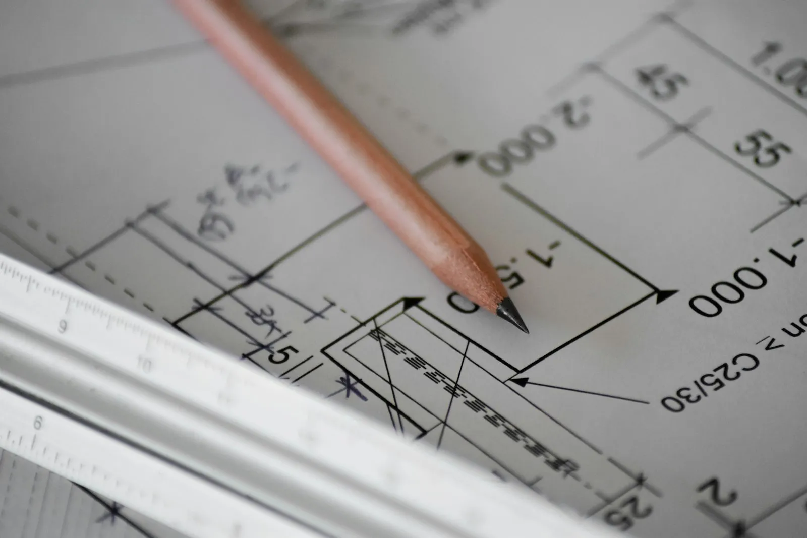Pencil and ruler on a set of building plans