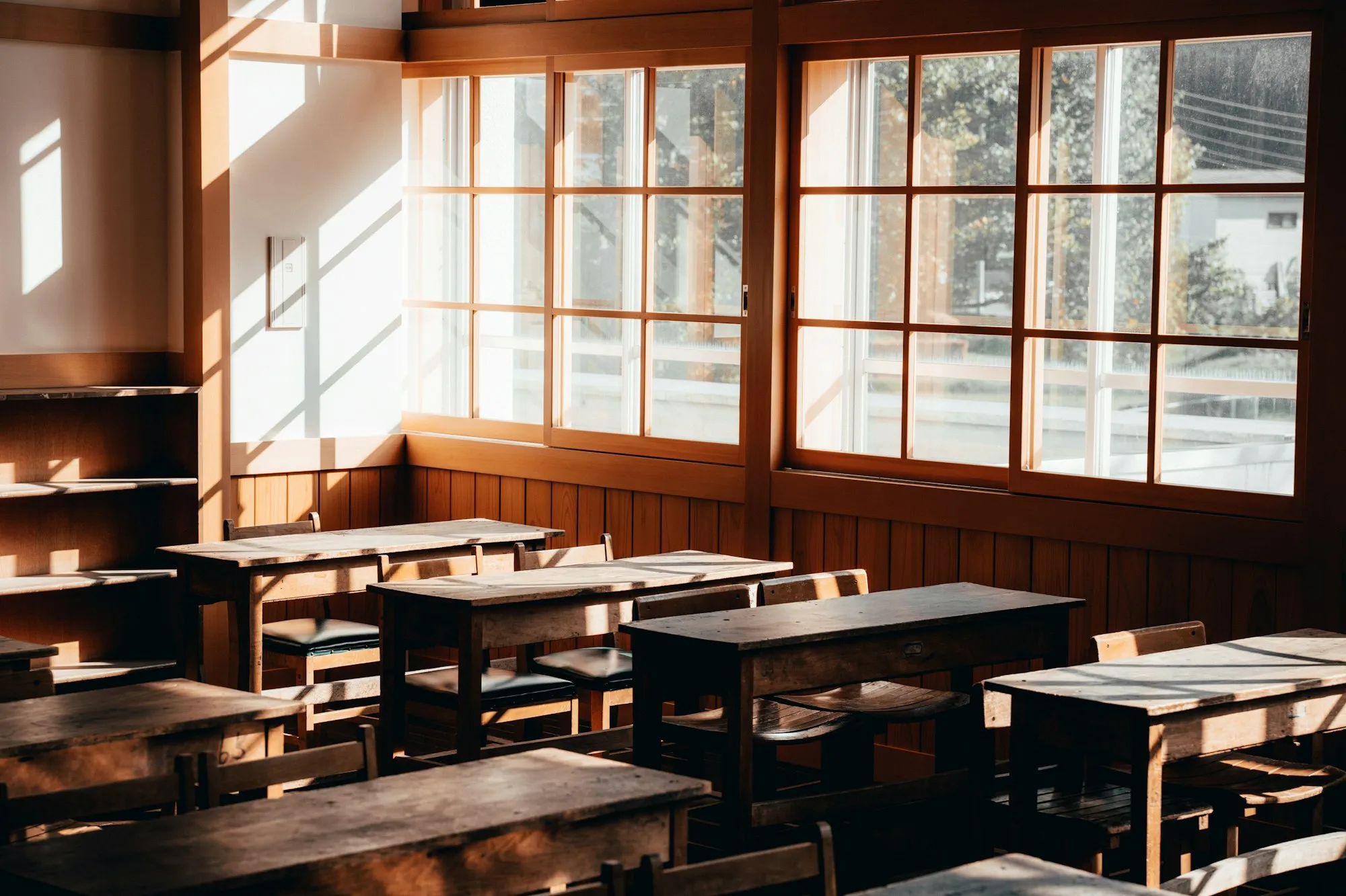 Sunlit classroom with wooden desks